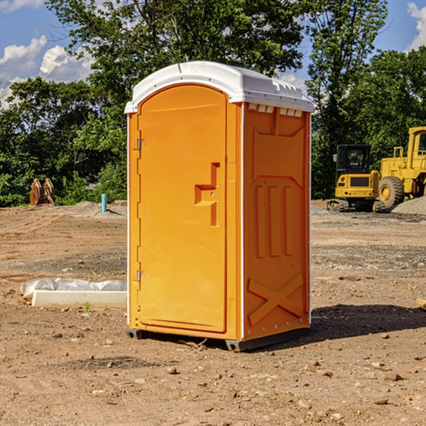 what is the cost difference between standard and deluxe portable toilet rentals in Mackinac County